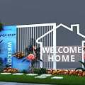 Floral Display Welcome Home Entrance Featuring White House Outline Flamingo Statues Green Plants And Flowers