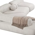 Modern Beige Sectional Sofa With Curved Design Soft Pillows And Throw Blanket