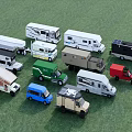 Various Types of RVs and Small Vehicles in Different Colors Parked on Green Grass