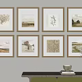Eight Framed Artworks On Wall With Console Table Vase And Books