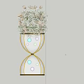Banquet Hall Decor With Hourglass Shaped Golden Frame White Flowers And Illuminated Spheres