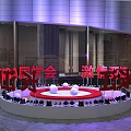Modern Building Exterior With Purple Lighting And Red Signage In City Plaza