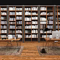 Spacious Study Room With Tall Bookcases Filled With Books And Wooden Desks