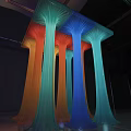Colorful Art Installation With Flowing Column Structures In Red Orange Green And Blue Hues
