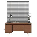 Wooden Desk with Table Lamp Open Book and Vase in Front of Window Blinds