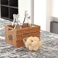 Decorative Ornament Set With Wooden Crate Glass Bottles Metal Wire Basket And Potatoes On Countertop