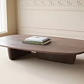 Oval Wooden Coffee Table With Two Books In Room With Window And Wall Molding