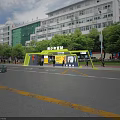 Youth Palace Station Green Shelter With Trees Pedestrians And Surrounding Buildings