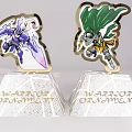 Warrior Ornaments With Purple Winged Figure And Green Cape Design On White Pedestals Golden Text