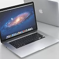 Apple MacBook Laptop With Open Galaxy Screen Display And Silver Body Design