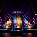 Vibrant Stage Setup With Colorful Lights And Large Screens For Event Performance