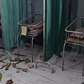 Abandoned Hospital Ward With Dilapidated Benches Bricks Debris On Floor And Vines Covering Walls