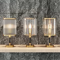 Multiple Lit Table Lamps With Glass Shades And Metal Bases On Wooden Shelf