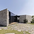 Modern Detached Villa with Stone Walls Black Facade and Stone Patio Entrance Area