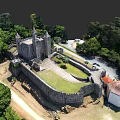 European Medieval Castle with Stone Walls Green Courtyard and Lush Trees