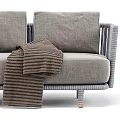 Modern Outdoor Sofa With Gray Fabric Plush Brown Cushions Woven Armrests And Blanket