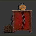 Vintage Red Cabinet With Orange Camera And Brown Suitcase On Wooden Tabletop