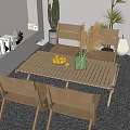 Wooden Table and Chair Set in Outdoor Balcony With Pebble Floor Green Vase and Cactus