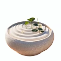 Garden Ornament With Spiral Sand Stone Bowl And Fresh Green Leaf Plants