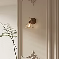 Modern Indoor Wall Sconce With Geometric Metal Frame And Warm Light Near Green Plant