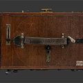 Vintage Electronic Device With Wooden Case And Metal Components Featuring Circular Holes And Knob