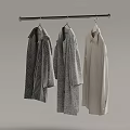 Three Different Patterned Coats Hanging On Metal Rod In Minimalist Space