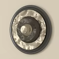 Round Wall Decor With Black Metal Frame And Light Textured Panel Mounted On Beige Wall