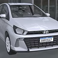 White Hyundai Sedan Car Displayed in Modern Showroom with Glass Walls