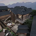 Traditional Chinese Homestay Building with Classic Tiled Roofs Mountain Views Courtyard and Lush Greenery