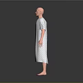 Human Figure Sculpture in Polka Dot Hospital Gown with Bald Head Standing on Gray Background