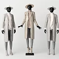 Mannequins In Light Colored Long Coats With Wide Brimmed Hats And Gray Pants