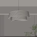 Modern Layered Pendant Light With White Shade And Soft Glow Near Green Plant