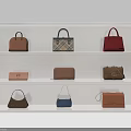 Various Stylish Handbags In Different Colors Displayed On White Shelves