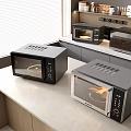 Three Black And Silver Microwaves On Modern Kitchen Countertop With Cabinets