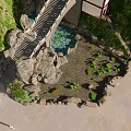 Ancient Architecture on Mountain Slope With Traditional Roof Stone Bridge and Flowing Stream