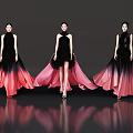 Women in elegant black gradient red long dresses standing on black background with reflections