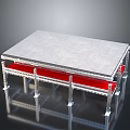 Modern Metal Frame Table With Gray Tabletop And Red Supports On Reflective Surface