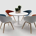 Modern Dining Table Set With White Round Table Colorful Chairs Wooden Legs And Potted Plants