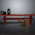 Red Wooden Bench With Two Black Oil Lamps And Brown Watering Can