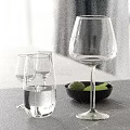 Elegant Modern Decorative Ornament Set With Glassware Black Bowl Green Fruits On Gray Countertop