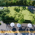 Garden Landscape With White Canopy Structure Green Lawn And Lush Trees Outdoor Tables And Chairs