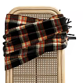 Light Wooden Footstool With Curved Frame Wicker Top And Draped Plaid Blanket