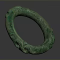 Green Circular Bronze Sculpture Featuring Intricate Decorative Carvings On Surface
