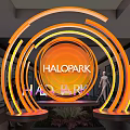 Halopark Indoor Neon Circular Installation With Orange Yellow Glow Mannequin And Plants