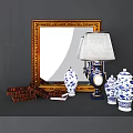 Decorative Ornament Set With Golden Framed Mirror Table Lamp Blue White Vases And Stacked Books