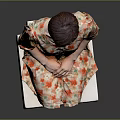 Child Sitting On White Block Wearing Floral Dress Against Gray Background