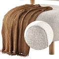 Light Beige Upholstered Leisure Chair With Curved Backrest Wooden Legs And Brown Knitted Blanket
