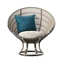 Modern Stylish Rattan Lounge Chair with Beige Cushion and Blue Decorative Pillow