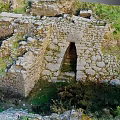 Ancient Stone Ruins Scenic Landscape Featuring Archway And Lush Green Grass