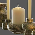 Natural Textured Stone Candle Holders With White Lit Candles And Various Designs
